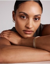 Michael Hill - 0.22 Carat TW Diamond and Created Emerald Huggie Hoop Earrings in 10kt Yellow Gold