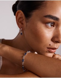 Michael Hill - Oval Cut Blue Created Ceylon Sapphire Gemstone and Diamond Drop Huggie Earrings in Sterling Silver