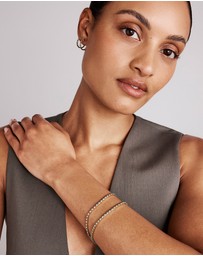Michael Hill - 0.22 Carat TW Diamond and Created Sapphire Huggie Hoop Earrings in 10kt Yellow Gold